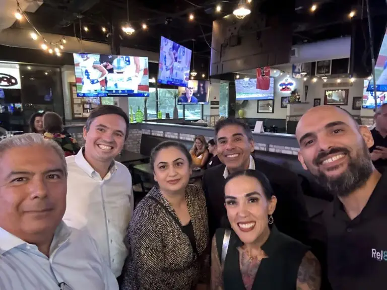Attendees smiling together at a Mind & Machine DFW networking event