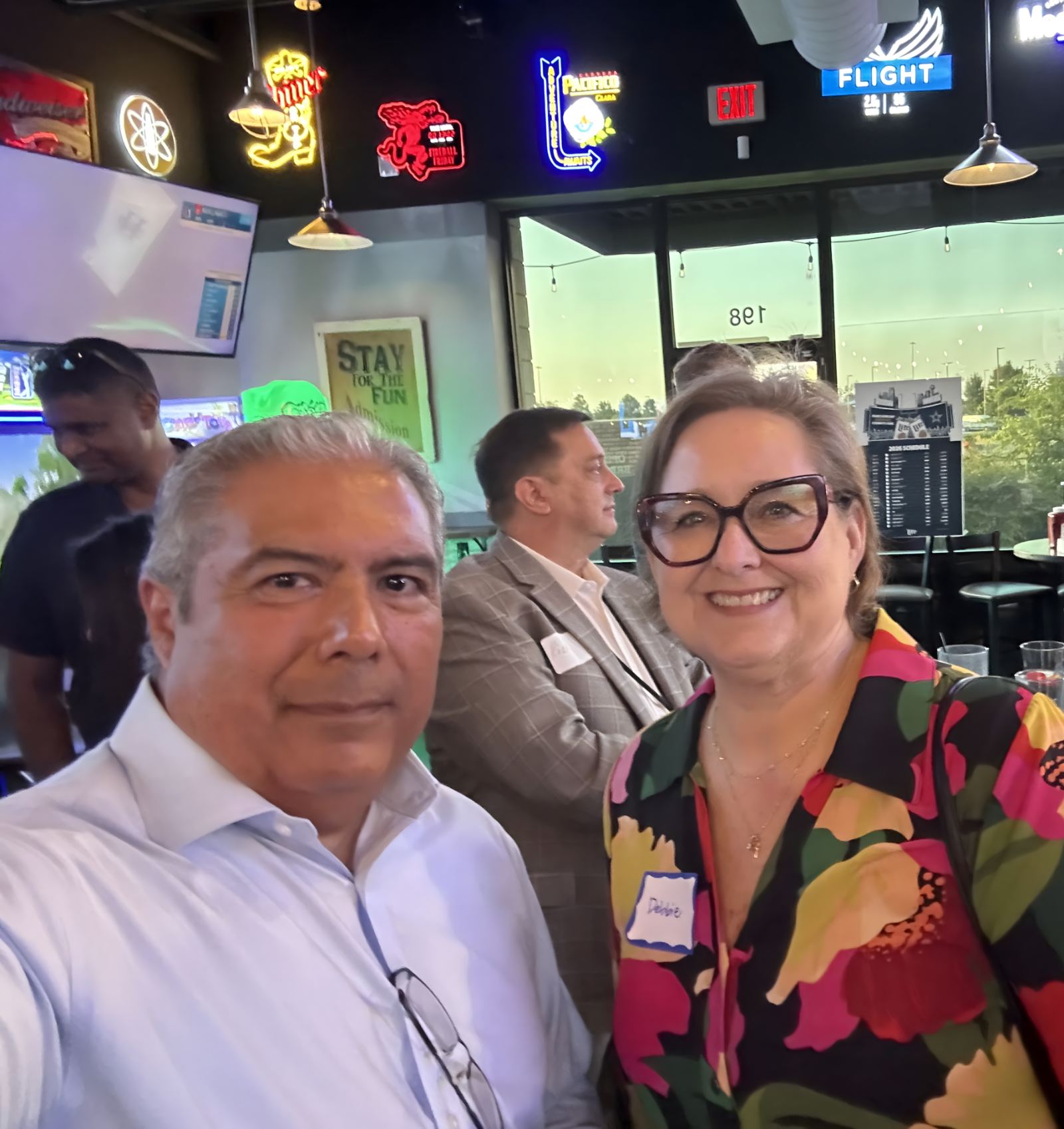 Two attendees smiling together at a Mind & Machine DFW networking event