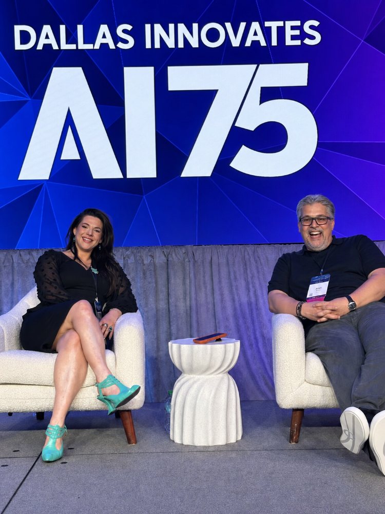 Two people seated on stage in front of a Dallas Innovates AI75 backdrop