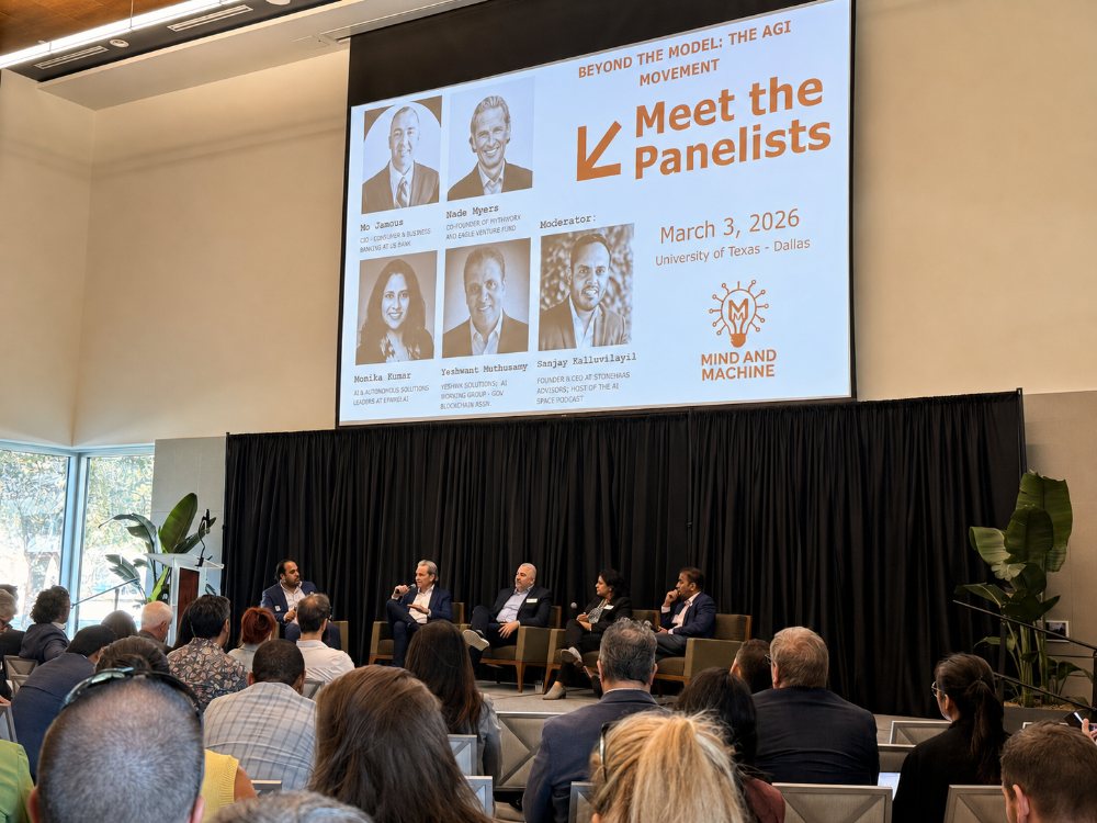 Panel discussion on stage at SMU with a Meet the Panelists slide behind them